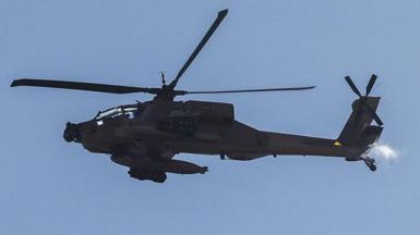 This picture taken from a position in northern Israel, on the border with southern Lebanon, shows an Israeli Air Force AH-64 Apache helicopter flying on 4 June 2026. 