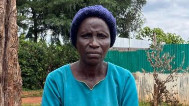 Agnes Barabara sits beside a tree near her home in Kenya