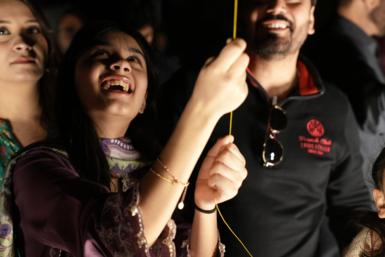A girl smiling who is holding a kite string