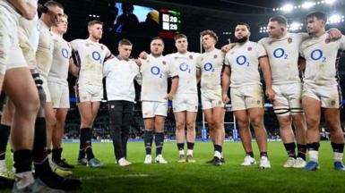 England players gather in on-pitch huddle