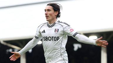 Harry Wilson celebrates a goal for Fulham with his arms outstretched