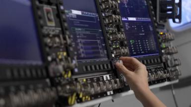 We see an astronaut training in a mission simulator.