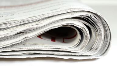 A stock image shows the edge of a folded newspaper