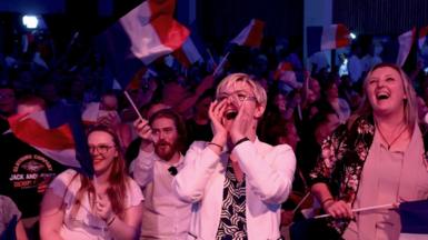 French National Rally supporters cheer at an election event