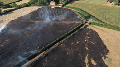 An aerial picture of fields on the Tetworth Hall Estate in Cambridgeshire. Part of the field is charred and damaged.