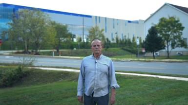Gregory Pirio in front of a data center near his house in Loudoun County