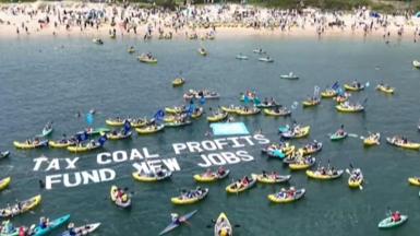 View of kayaks with banner floating on sea