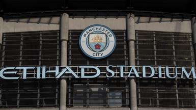 A general view of the Etihad Stadium sign and badge at Manchester City's home ground