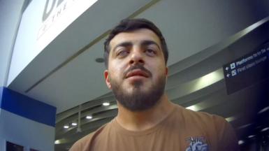Undercover image of young man with a beard and a brown T-shirt. He has a one glass eye.