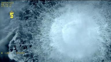 A screen grab from Danish Defense shows a gas leak causes bubbles on the surface of the water at Sea in Sweden on September 30, 2022
