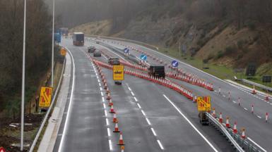 Roadworks and traffic cones can be seen on the multi-lane road with cars diverted, on the Heads of the Valleys road in Brynmawr, Wales in December 2020.