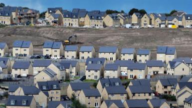 An aerial view of a recently built development of mixed priced homes in Bradford, England