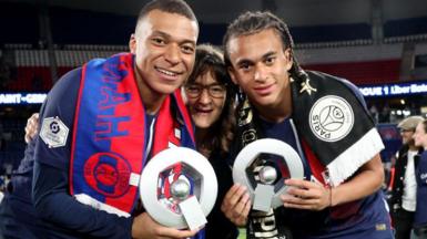 Kylian Mbappe and his brother Ethan along with their mother