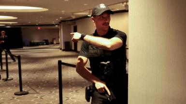 Secret Service agent gestures as a shooter opens fire during the annual White House Correspondents' Association dinner in Washington, D.C
