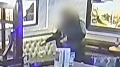 CCTV footage of a man spiking women's drinks in a pub.