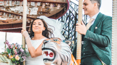 Harmony and Seán smiling on merry-go-round 