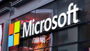 The Microsoft logo on the side of a shop in New York. The logo is four squares, in the colours red, green, blue and yellow, to represent its Windows software.