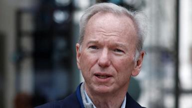 Close up of Eric Schmidt wearing a dark jacket and pinstriped shirt