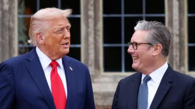 US President Donald Trump with British Prime Minister Sir Keir Starmer in September 2025. Trump wears a blue jacket, red tie and a gold pin featuring the American flag. Starmer wears a blue jacket, blue patterned tie and his customary black-rimmed glasses.
