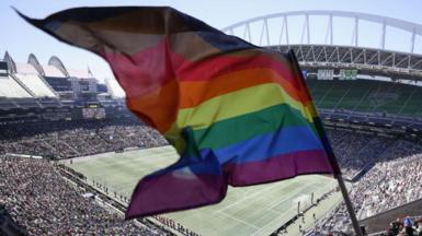 A rainbow flag being flown at the Seattle Stadium.