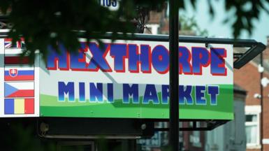 Sign above a shop that reads Hexthorpe Mini Market - in blue capital letters