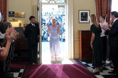 New Prime Minister Andy Burnham and his wife Marie-France van Heel are greeted by staff as he walks into 10 Downing Street, London, for the first time as Prime Minister. Picture date: Monday July 20, 2026. 