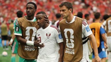 Qatar's Assim Madibo is comforted by team-mates after getting sent off in their World Cup game against Canada in 2026