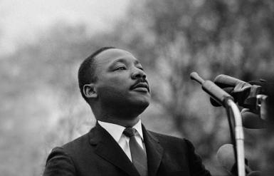Martin Luther King Jr photographed speaking before a massive crowd in Alabama 