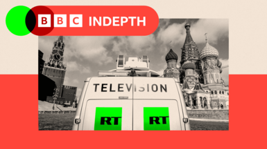 RT television broadcast van is seen parked in front of St. Basil's Cathedral and the Kremlin