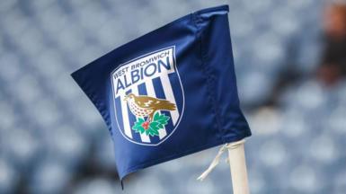 A corner flag with the West Brom badge