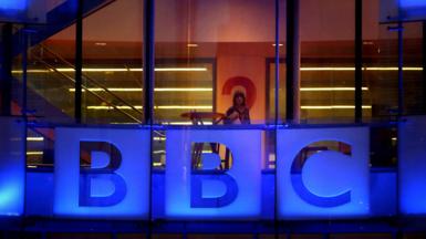 An employee walks inside BBC headquarters at New Broadcasting House
