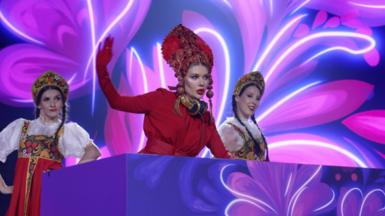 Russians dressed in traditional clothing dance at Intervision 2025