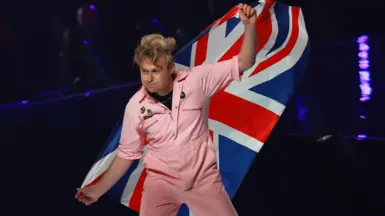Look Mum No Computer waves a British flag as he walks onto the stage at the 2026 Eurovision Song Contest