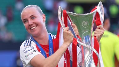 Arsenal forward Beth Mead holding the Women's Champions League trophy