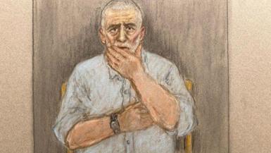 A court sketch showing Peter Sullivan, 68, who has grey and white hair and a blue shirt, holding his hand to his face.
