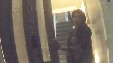 Woman opening a front door to a house