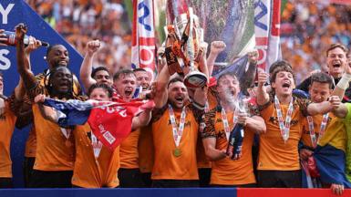 Lewis Coyle of Hull City lifts the Championship play-off final trophy after being promoted to the Premier League