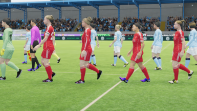 Women's footballers walking in the video game. Players wearing Liverpool kits and Manchester City kits can be seen.
