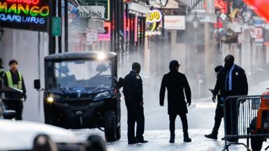 A group of law enforcement members work at the site of the attack