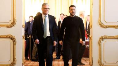 Keir Starmer walks with Ukrainian President Volodymyr Zelenskyy as he hosts a European Leaders Summit at Lancaster House in London