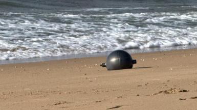 One of the six mysterious large silver spheres washed up on Forrest Beach in Queensland.
