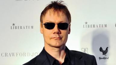 William Orbit wearing dark glasses and looking at the camera in 2012