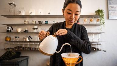 A barista pours filter coffee at Dou Coffee in Shanghai