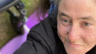 A woman smiles at the camera 