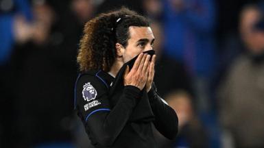 Marc Cucurella pulls his shirt up over his mouth after defeat at Brighton