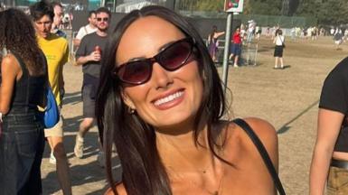 Lauren who has dark hair is smiling whilst wearing sunglasses