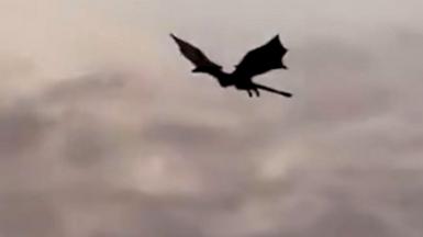 Dragon flies over Glasgow at sunrise