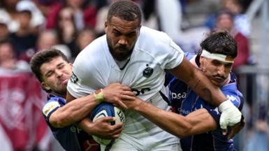 Bath's Ollie Lawrence is tackled by Bordeaux players