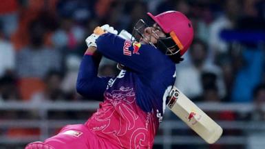 Vaibhav Sooryavanshi holding a cricket bat over his shoulder