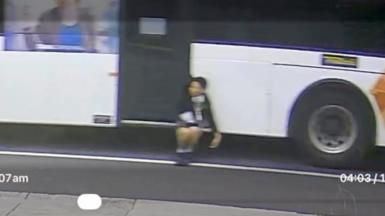 CCTV captures boy dangling off side of a bus
